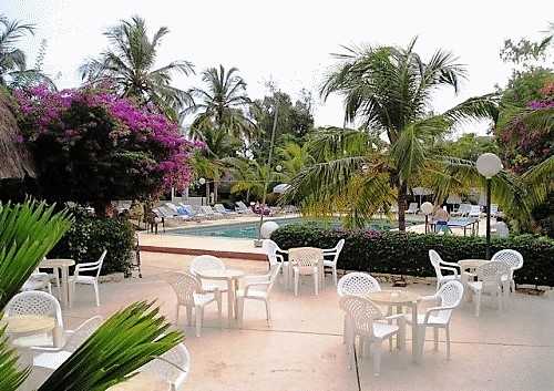 Hôtel Les Bougainvillées 3* à Saly, au Sénégal, piscine, palmiers, tables et chaises
